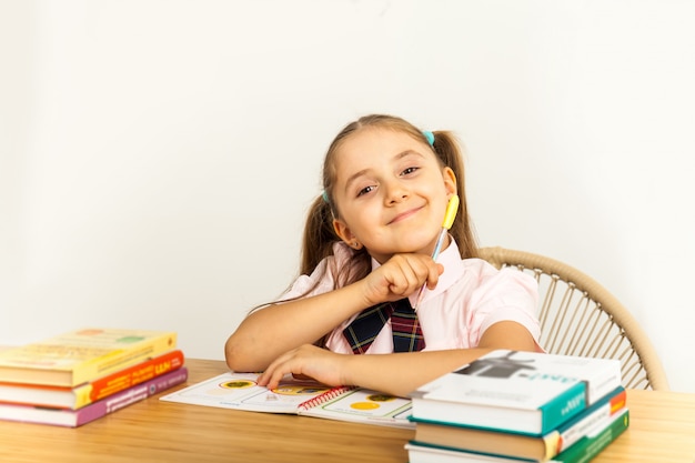 Girl studing at table on white background