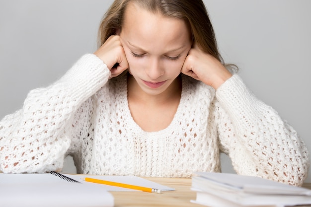 Girl studying on a wooden table