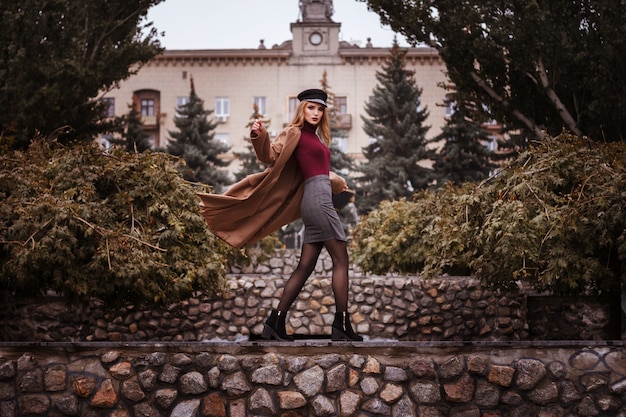 Girl in stylish autumn clothes in the park