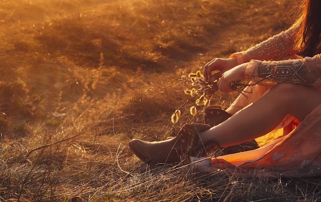 Girl in stylish clothes at sunset