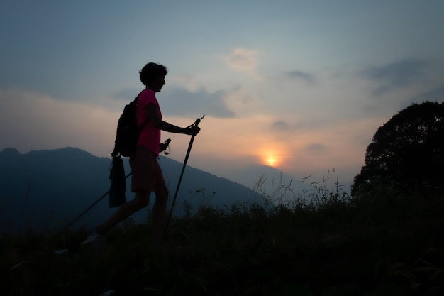 Girl during a sunset evening trek in the hills