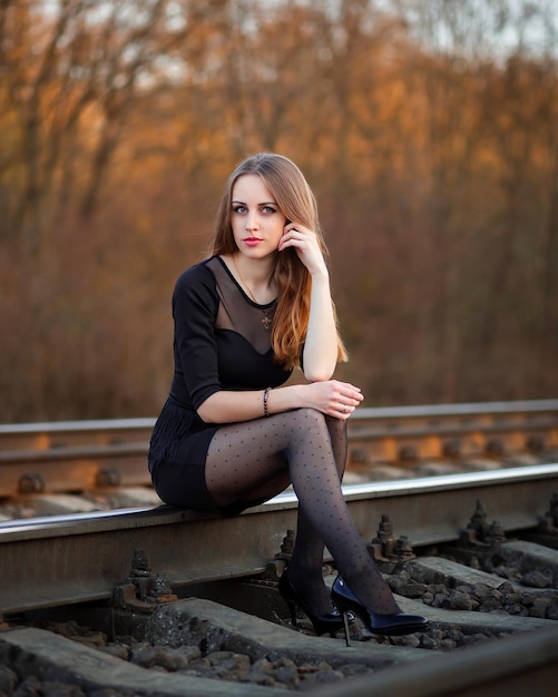 Girl at sunset in nature in a dress and black shoes