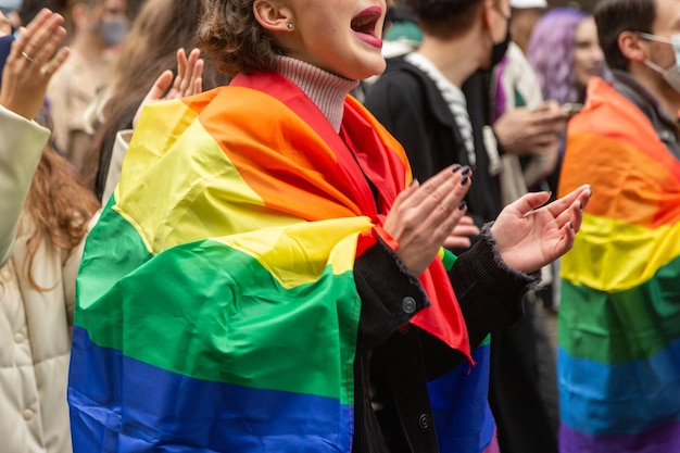 A girl supporting the LGBTQ rally in Kyiv, wrapped in a rainbow flag during the Pride Parade. Concept LGBTQ.