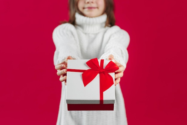 Girl in sweater gives a present