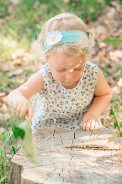 Girl sweeps a stump with a slop. High quality photo