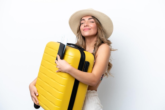 Girl in swimsuit in summer holidays isolated on white background in vacation with suitcase and passport