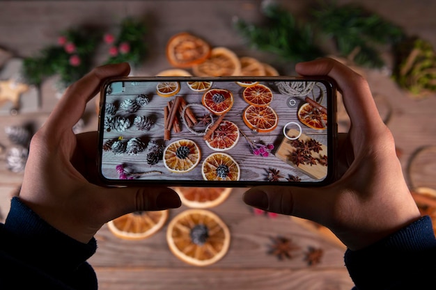 The girl takes pictures of Christmas decorations on a smartphone Celebrating Christmas and New Year