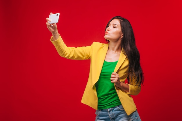 The girl takes a selfie on a mobile phone