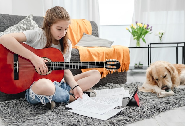 Girl teenager practicing guitar playing