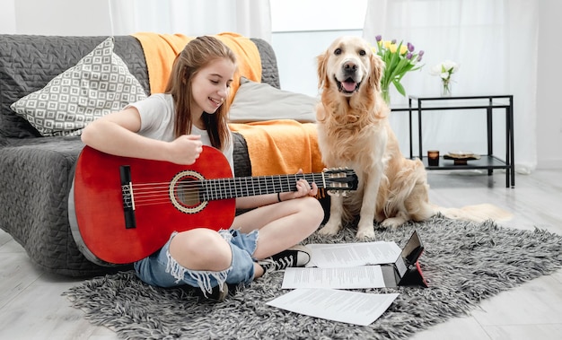 Girl teenager practicing guitar playing