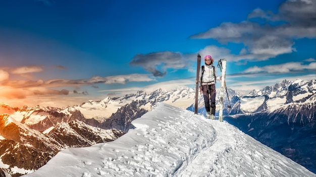 Girl in top of the mountain on skis in hand