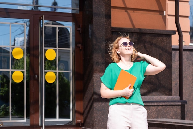 Girl Tourist walking and consulting a guide in a tablet and watching amazed the street