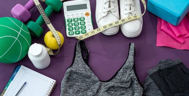 Girl training in the gym pulled out of the bag equipment in the form of skipping ropes top