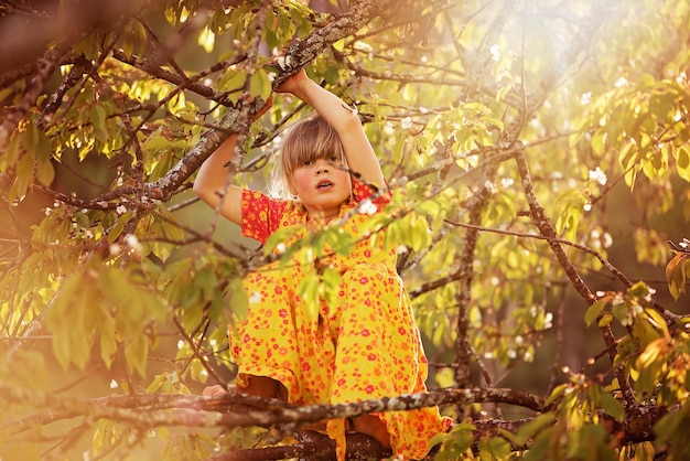 A girl in a tree with a branch and the word cherry on it