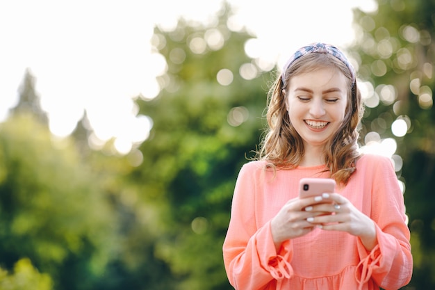 Girl using smart phone at outdoor and green nature