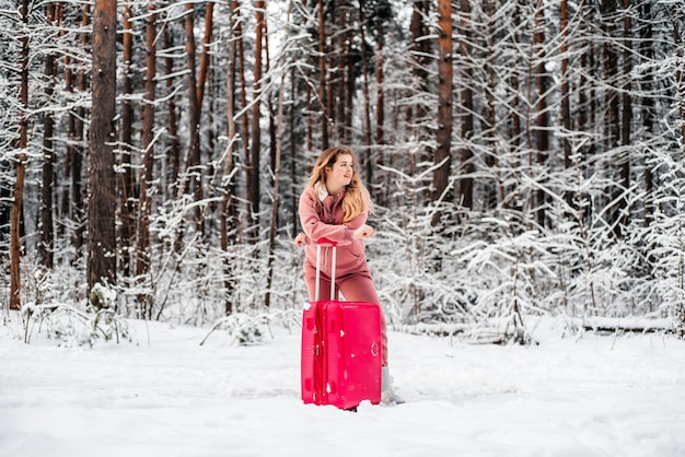 Girl votes in the woods by a broken car.Winter forest, frost and snow.