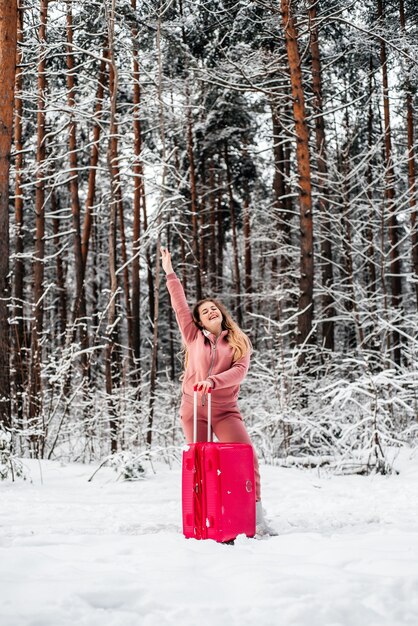 Girl votes in the woods by a broken car.Winter forest, frost and snow.