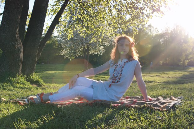 A girl on a walk in an autumn park. Young red-haired girl in the spring on nature.