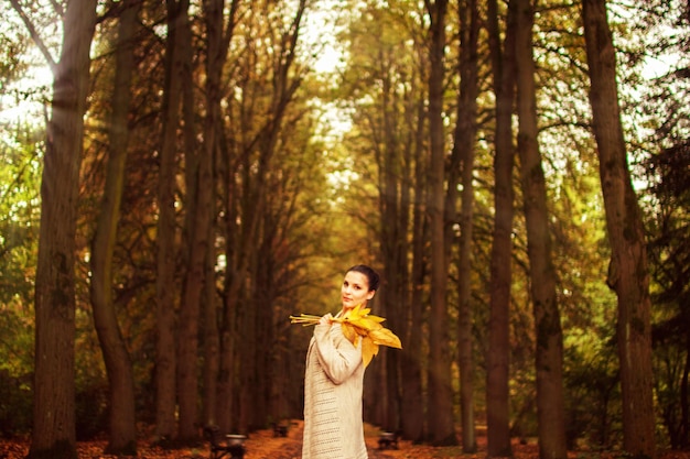 Girl walking in the park in autumn