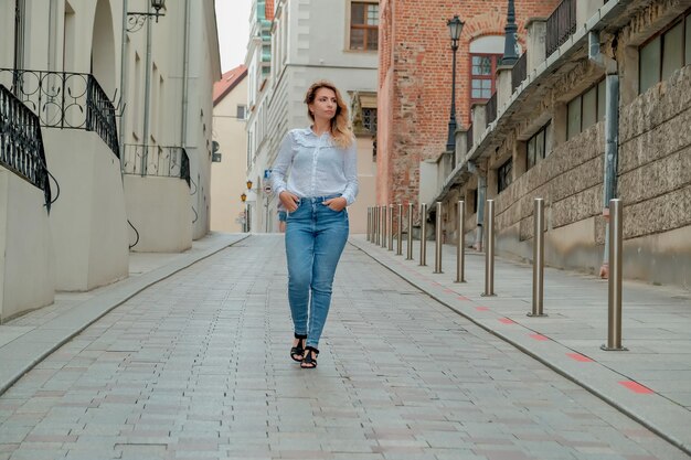 The girl walks the European streets looks at your advertisement thoughtful girl