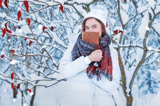 The girl walks through the winter forest