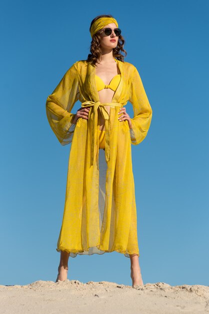 Girl wearing beach wear and posing at the sandy beach