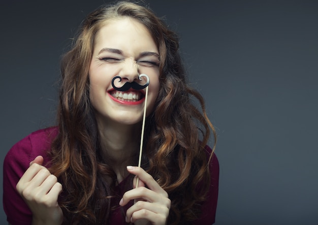 Girl wearing fake mustaches,