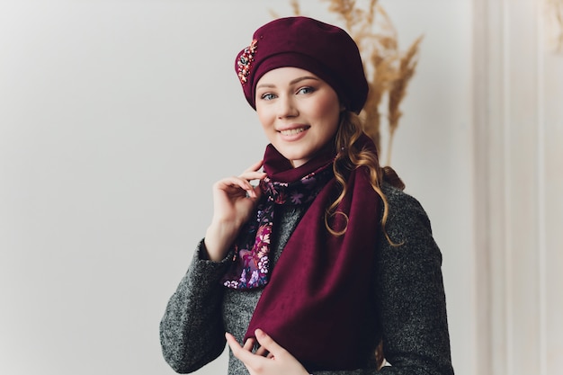 Girl wearing knitted warm hat, coat and scarf