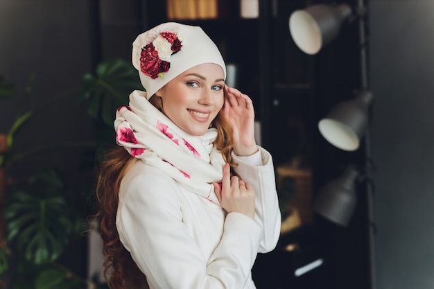 Girl wearing knitted warm hat, coat and scarf