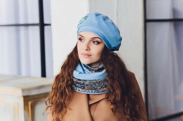 Girl wearing knitted warm hat, coat and scarf