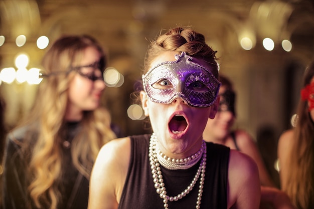 Girl wearing a mask looking shocked