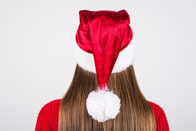 Girl wearing santa hat and red pullover