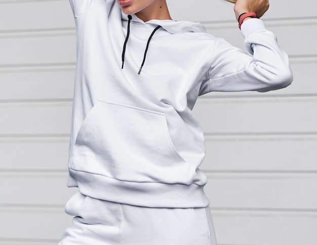 For Girl wears white hoodie and pants Blonde woman in loose tracksuit with no logo