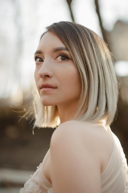 Girl in a wedding dress in nature Portrait of a beautiful girl in the sun