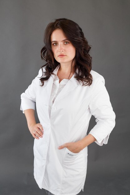 Girl in a white coat on a dark background