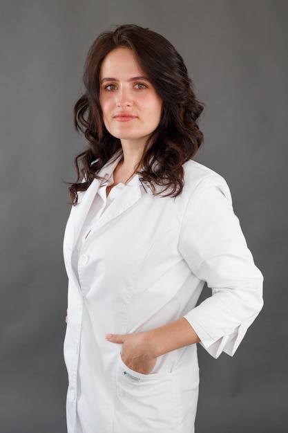 Girl in a white coat on a dark background