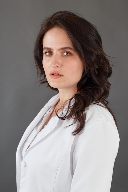 Girl in a white coat on a dark background