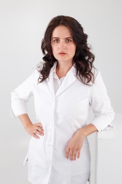 Girl in a white coat on a white background