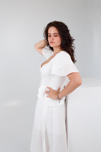 Girl in a white dress on a white background