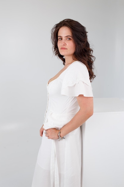 Girl in a white dress on a white background