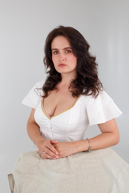 Girl in a white dress on a white background