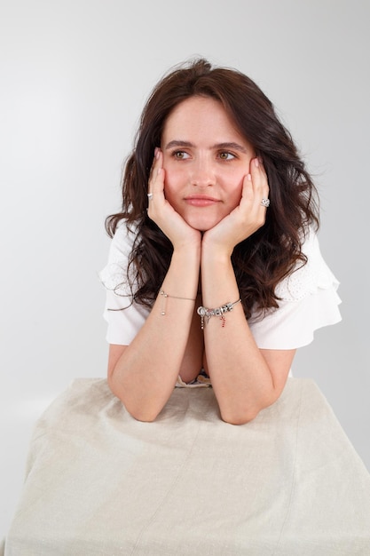 Girl in a white dress on a white background