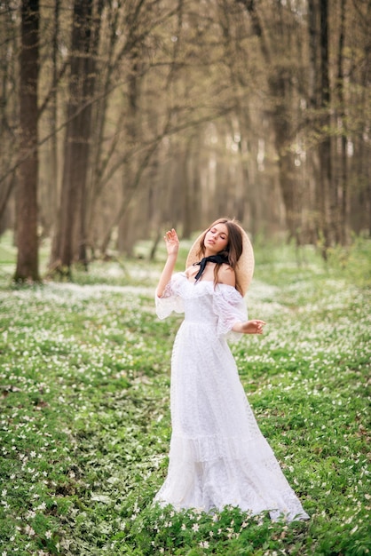 Girl in a white long dress in a spring forest Forest nymph