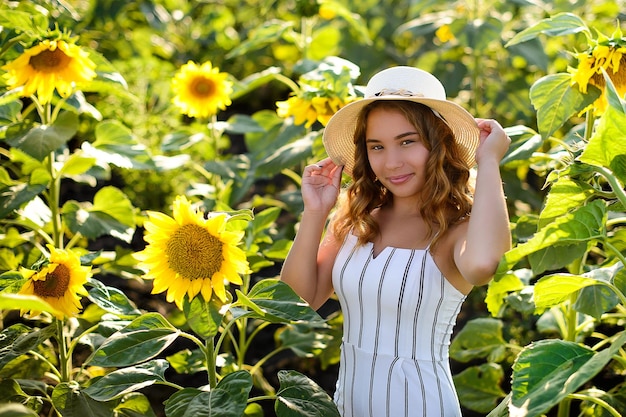 A girl in white in sunflowers Summer time