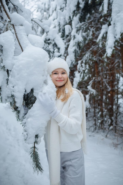 A girl in a winter forest, blonde, a fun walk in nature