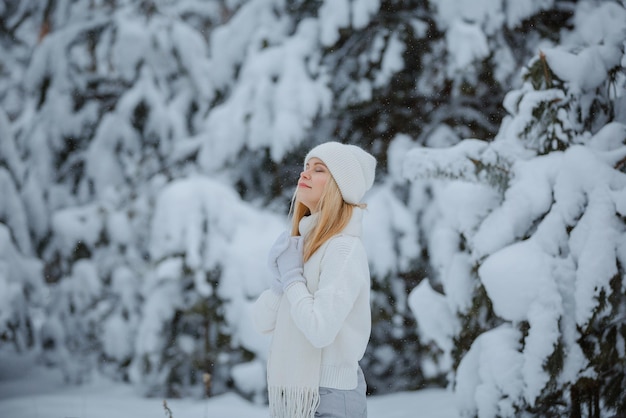 A girl in a winter forest, blonde, a fun walk in nature