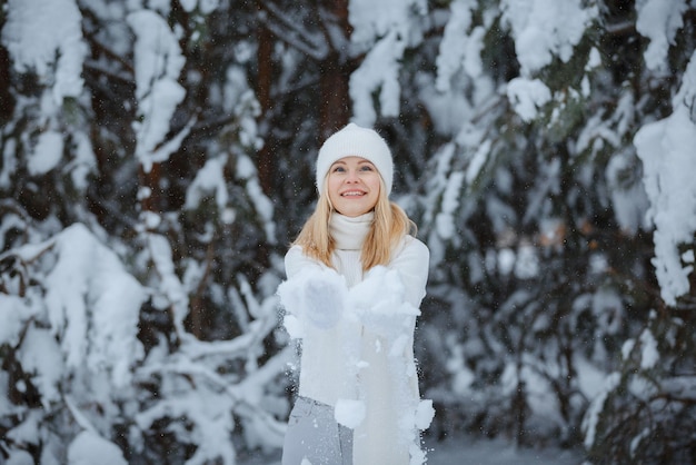 A girl in a winter forest, blonde, a fun walk in nature