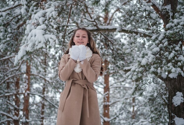 girl in winter forest with white trees and abundant snow