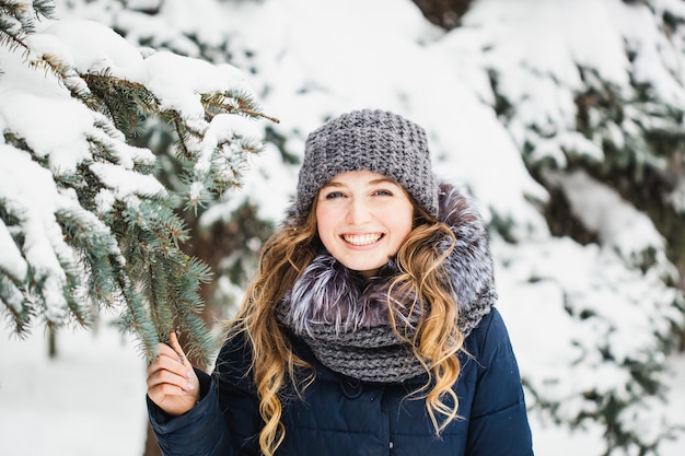 Girl in winter park covered of snow