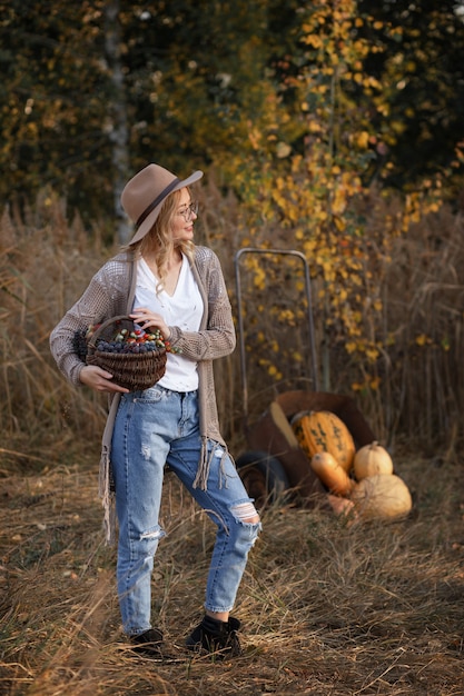 Girl with autumn pumpkins. Harvesting